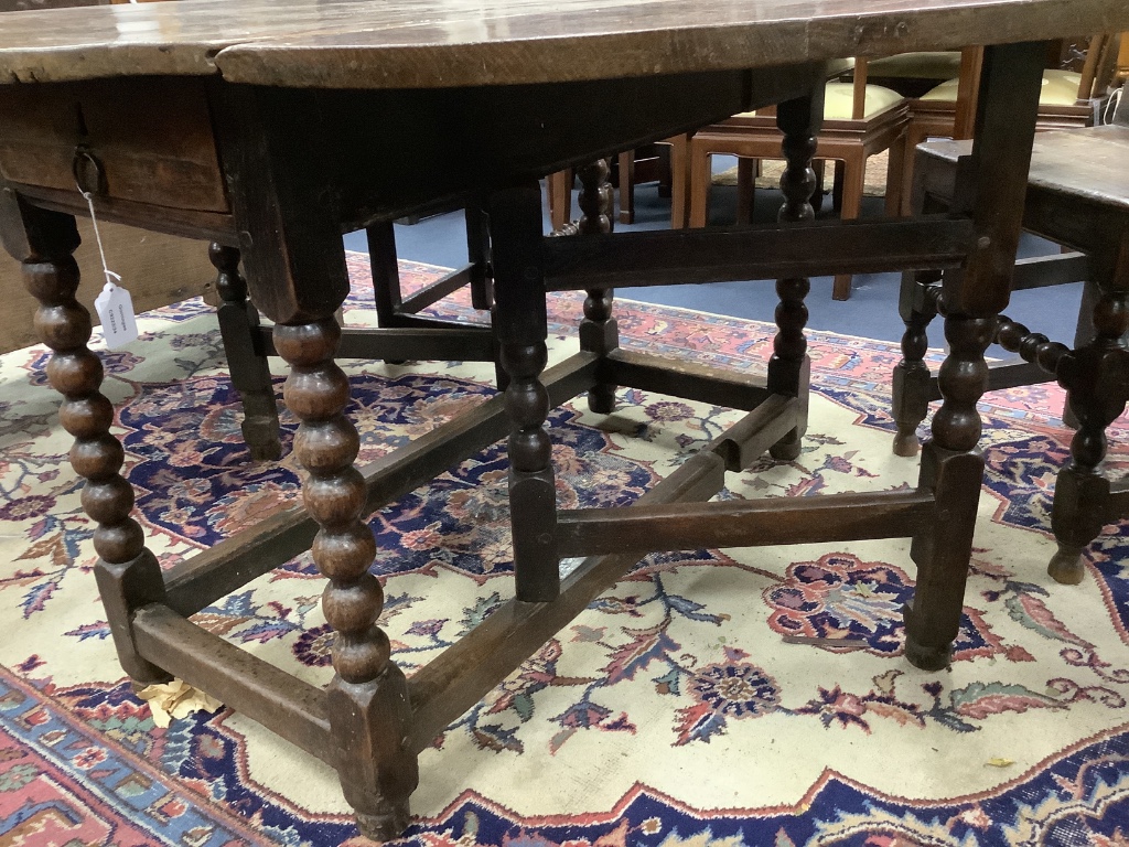 A six-seater oak gateleg dining table, late 17th century, 148cm (extended) depth 122cm, 74cm high.